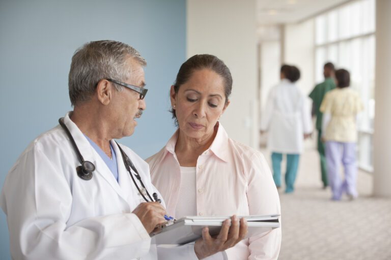 Doctors talking to woman in hospital