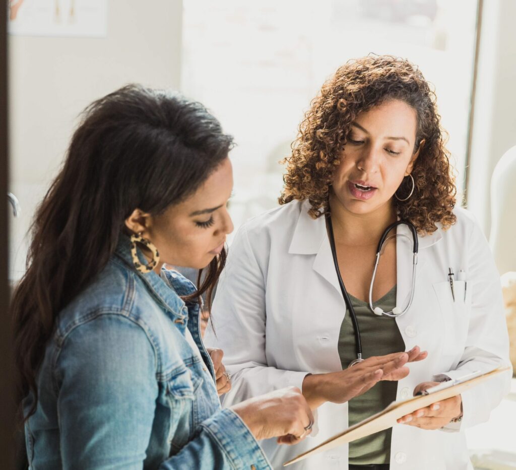 Pediatrician talks with patient’s mother