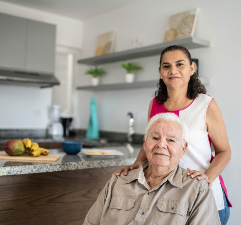 Portrait of senior man and his daughter (or home caregiver) at home
