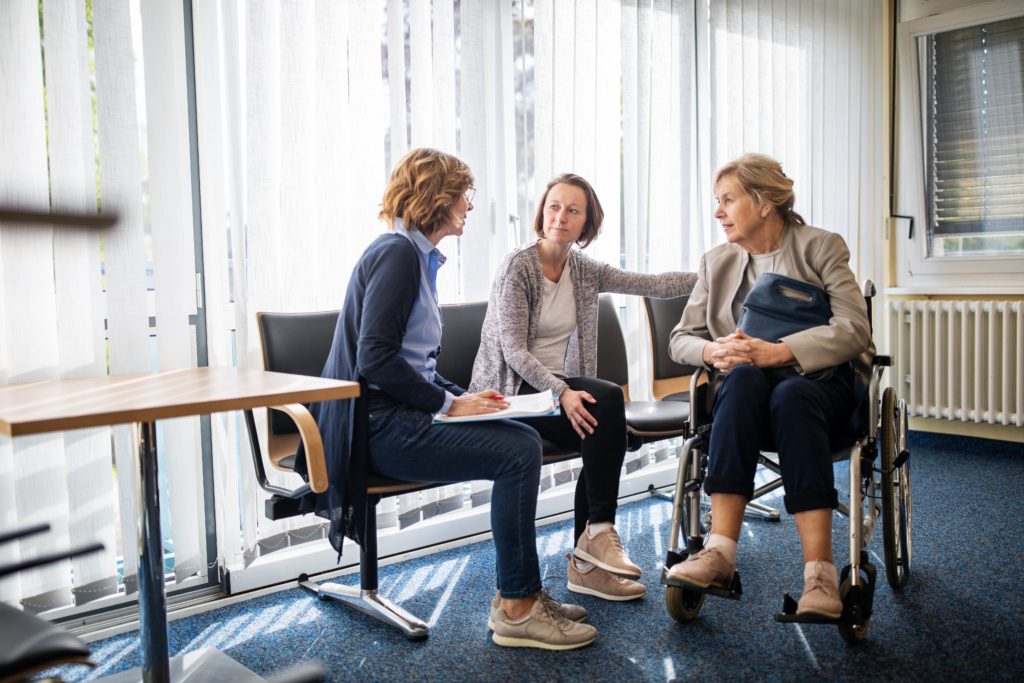 Therapist discussing with women in waiting room